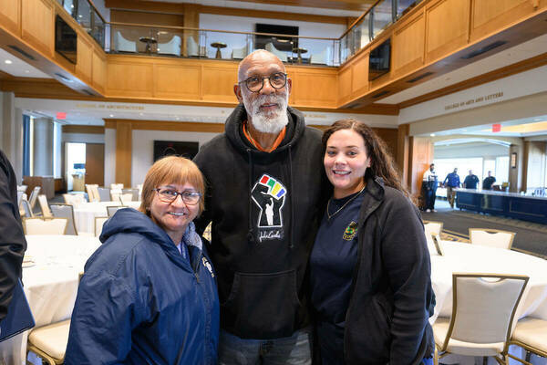 Spring Staff Unity Summit special guest, John Carlos (center), poses for a photo with two Notre Dame employees.