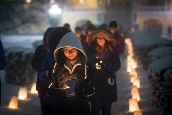 Students and staff walk after a midnight prayer service