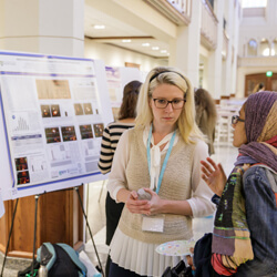 Jamie Luther talks with another student about her research.