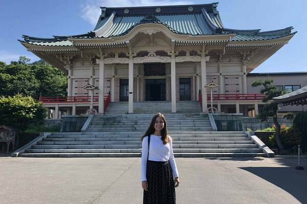 Francie Shaft standing in front of a temple