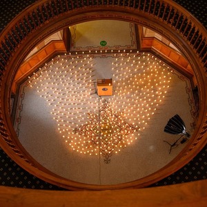 A view of the rotunda floor covered in candles from a couple balconies above.