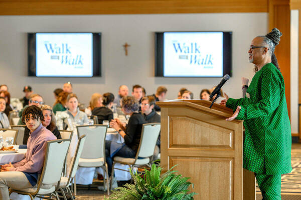 Eric Love speaks to attendees at the 2024 Unity Summit, part of Walk the Walk Week