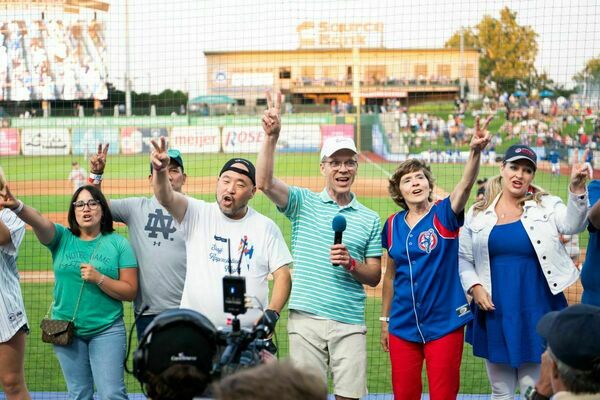 Members of the Office of Information Technologies sing Take Me Out to the Ballgame during the 7th Inning Stretch as part of Staff Appreciation Night at the South Bend Cubs.