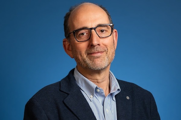 Theology associate professor Abraham Winitzer, who appears as a white male with glasses sitting in front of a blue background.